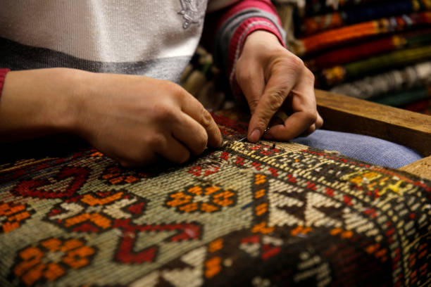 Skilled artisan repairing oriental rug